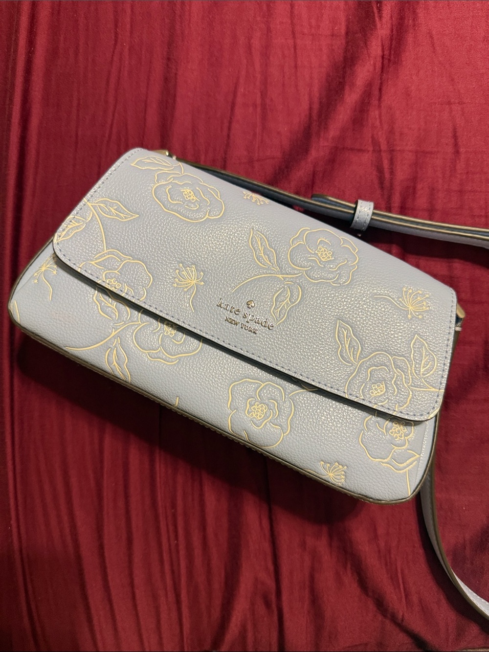 kate spade light blue leather crossbody with white floral print